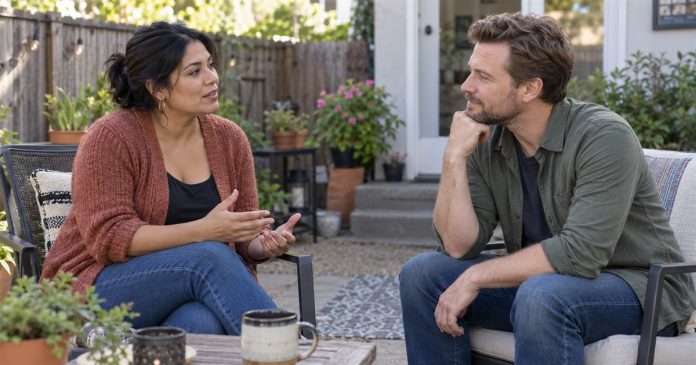 Two adult partners discussing feelings and listening to each other in a backyard.