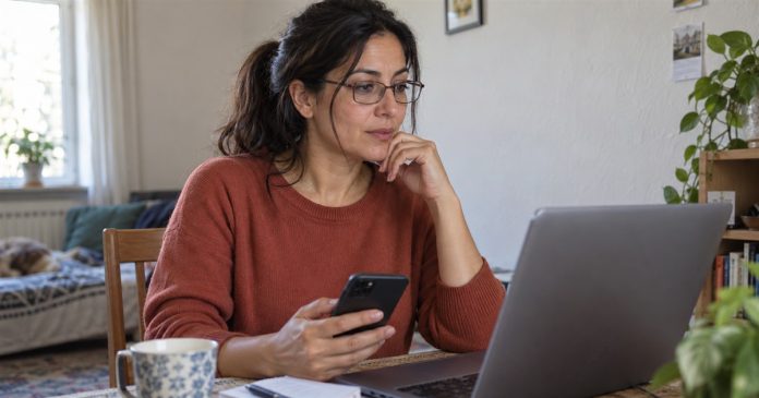 Woman comparing reading formats with a smartphone and open laptop at home.